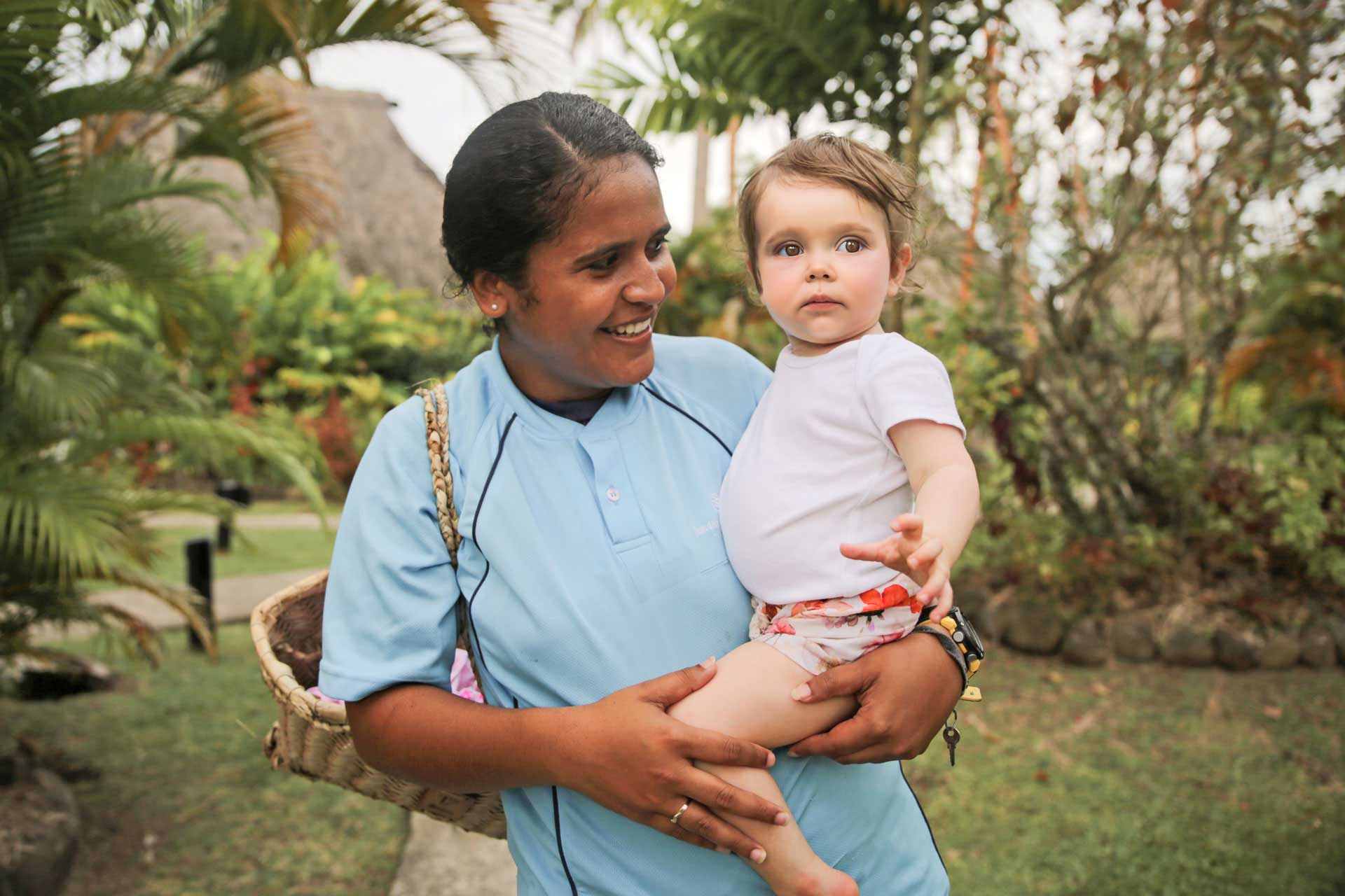 Image shows a dedicated nanny with a toddler. Each child 5 and under is assigned a dedicated 'nanny' for the duration of their Fiji vacation with kids.