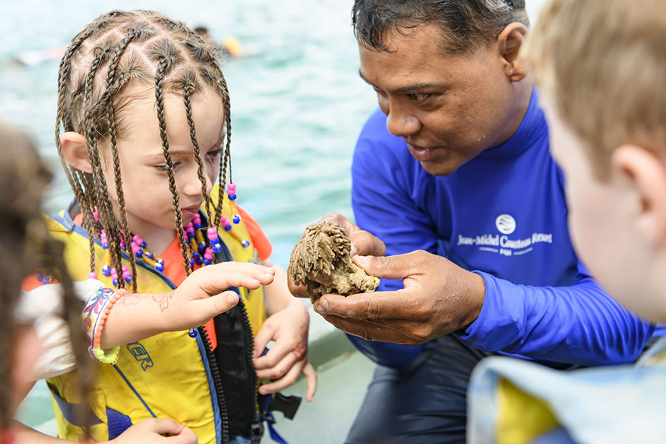 Image shows little children learning first hand from a resident Marine Biologist as part of endless activities for families of all ages.