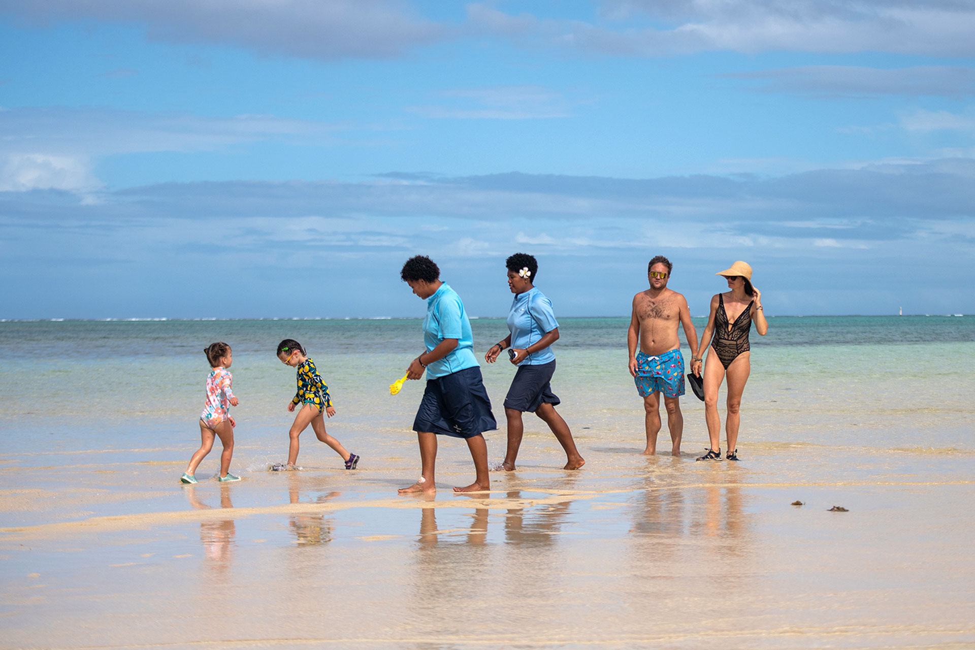 Image shows a family on vacation along with 2 dedicated nannies at Jean-Michel Cousteau Resort Fiji, an all-inclusive family resort in Fiji.