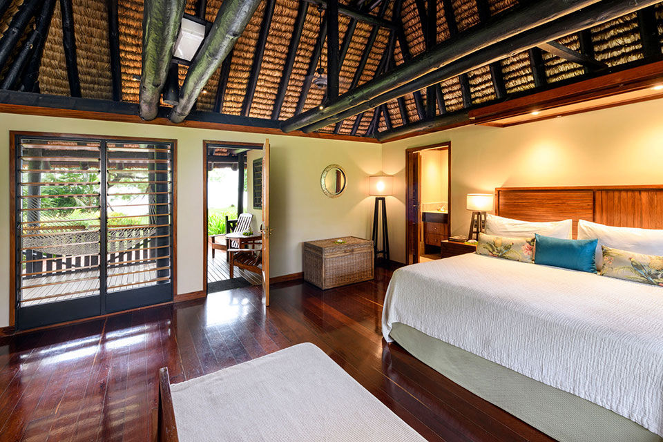 An image of a Fijian style Oceanfront 2-bedroom bure with contemporary furnishings at Jean-Michel Cousteau Resort Fiji.