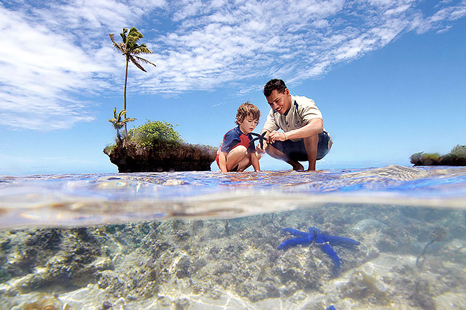 A resident biologist seen spending time educating a child. Jean-Michel Cousteau Resort, Fiji, a pioneer in Eco-Luxury, champions sustainability, ecological preservation, and community education.